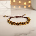 Bracelet tressé perles à facettes dorées