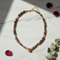 Collier rhodonite, pierre de soleil et spinelle noire